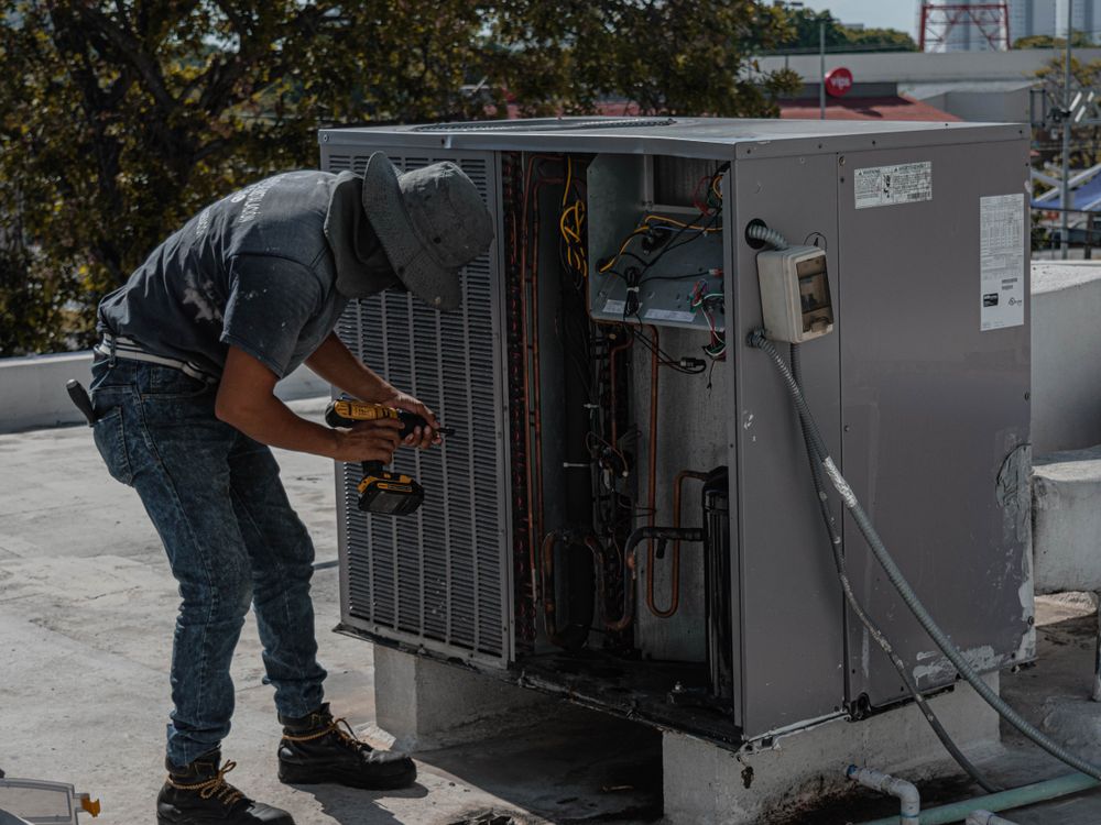 Technician installing a new high-efficiency air conditioning system